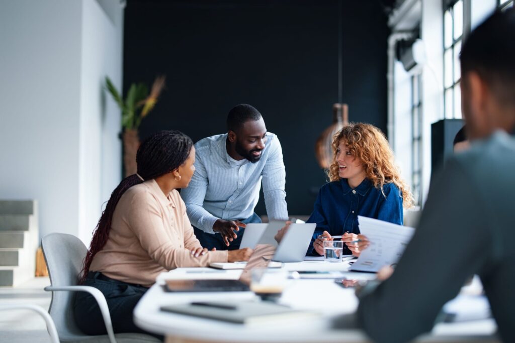 team of business associates conversing at a table